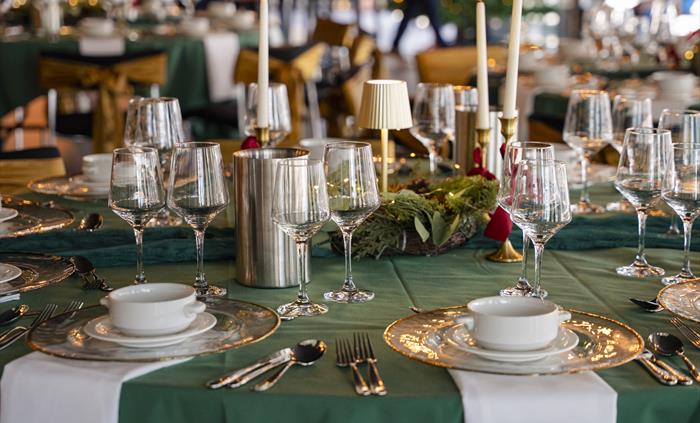 Festively decorated dining tables prepared for a Christmas party at Principality Stadium, Cardiff.